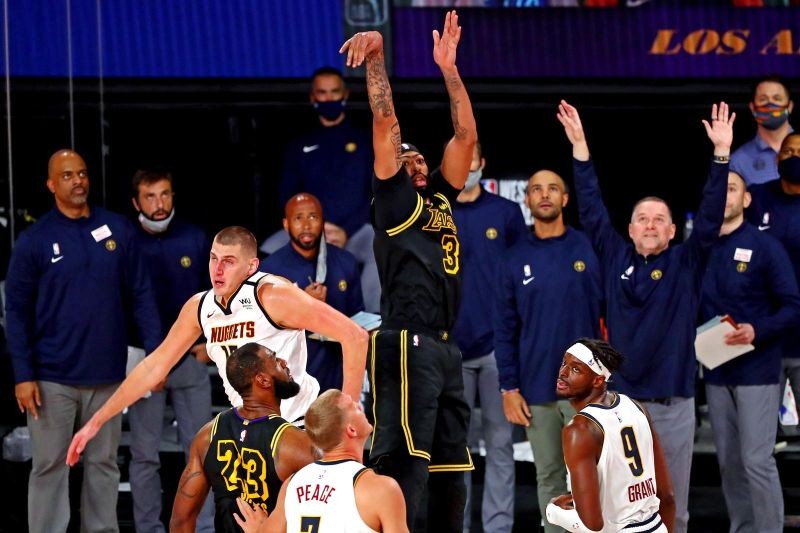 Los Angeles Lakers forward Anthony Davis (3) makes the game winning basket against Denver Nuggets center Nikola Jokic (15) during the fourth quarter in game two of the Western Conference Finals of the 2020 NBA Playoffs at AdventHealth Arena. (Credit: Kim Klement-USA TODAY Sports via Reuters)